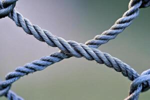 Entangled Network A Close-Up Depiction of Intertwined Ropes Creating a Mesh-Like Structure, Showcasing Strength, Connection, and the Beauty of Complex Interplay Explore the Detailed Textures photo