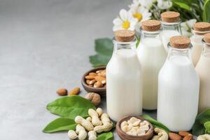 Explore a delightful array of plant-based milk alternatives with this vibrant image showcasing various types of vegan milk, including almond, cashew, peanut, and more, beautifully arranged with fresh photo
