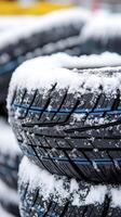 Explore the winter's grip on automotive safety with a close-up view of snow-covered tires, highlighting the challenges of driving in icy conditions Discover the importance of tire traction and tread photo