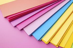 Vibrant colored paper collection showing a variety of pastel shades from pink and red to yellow and blue, perfect for art projects, crafts, or creative backgrounds, use this high-quality image for photo