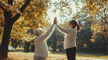 Capture heartwarming moments with a senior woman and her caregiver as they share a joyful high-five in a sun-drenched autumn park, creating memories that will last a lifetime Witness the beauty of photo