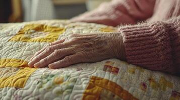 Close-up image showcasing the delicate, aged hand resting gently upon a vibrant, handmade quilt, symbolizing warmth, comfort, and the rich tapestry of life experiences This evocative image speaks of photo