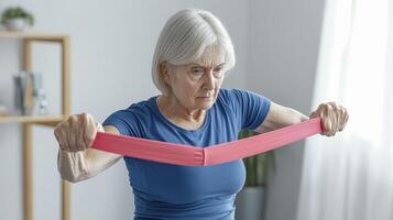 Empowering Active Aging Senior Woman Engaged in Strength Training with Resistance Band at Home, Promoting Wellness and Vitality Through Accessible Exercise Discover the Benefits of Gentle Workouts photo