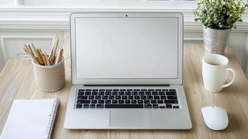 Work from Home Setup Minimalist Laptop Workspace with Coffee and Plant, A Clean and Productive Desktop Environment featuring a Silver Laptop with a Blank Screen, a White Coffee Mug, a Potted Green photo