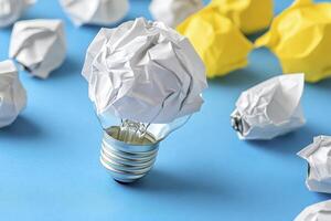 Unlocking Creativity A Visual Metaphor of Ideas Blooming from Crumpled Paper Light Bulb on a Blue Background Explore the concept of innovation, brainstorming, and problem-solving with this photo