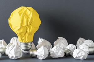 Unleash Your Creativity A Vibrant Yellow Paper Light Bulb Symbolizing Innovation and Bright Ideas, Surrounded by Crumpled White Paper, Represents the Journey from Conception to Realization, Sparking photo