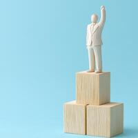 Triumph over adversity A symbol of unwavering spirit and leadership, showcasing a figurine standing atop blocks Capturing success, ambition, and the relentless pursuit of excellence, this image photo