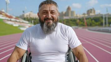 Sweaty Smiling Man in Wheelchair on Running Track photo
