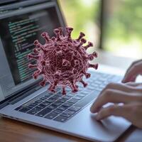 Person Working on Laptop with 3D Virus Model photo