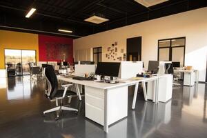 Modern Open Plan Office Interior with White Desks and Bright Lighting photo