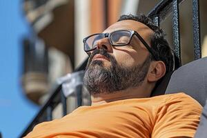 Man Relaxing Outdoors on Sunny Day in Orange Shirt photo