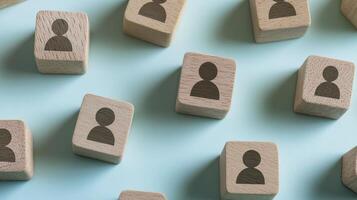 Wooden Blocks with Person Icons on Light Blue Background photo