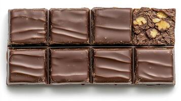 Indulge in the Visual Delight of Gourmet Chocolate Squares A Captivating Close-Up Showcasing Rich, Dark Chocolate Pieces Arranged Neatly, Complemented by a Nutty Brownie Variant Each Square Promises photo