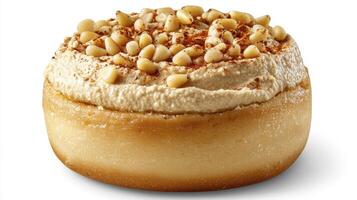 Indulge in a captivating close-up of a delectable donut adorned with a luscious topping and scattered pine nuts, enticingly presented against a pristine white background, capturing every photo