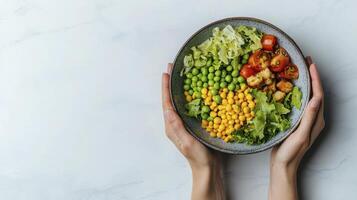 Healthy Eating A vibrant bowl brimming with fresh, plant-based ingredients, showcasing a colorful array of vegetables, including sweet corn, peas, lettuce, and roasted tomatoes, perfect for a photo