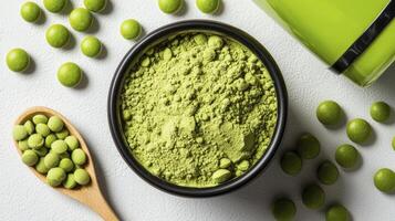 Explore the vibrant world of green tea with this captivating image showcasing matcha powder in a black bowl, surrounded by green tea candies and a wooden spoon filled with more candies Perfect for photo