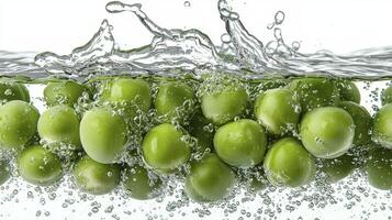 Discover vibrant freshness with this captivating image showcasing plump green peas cascading into pristine water, creating a mesmerizing splash Witness the symphony of colors and textures as the peas photo