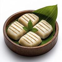 Delicious grilled scallop appetizers presented in a rustic wooden bowl alongside a vibrant green leaf, perfect for culinary enthusiasts and fine dining experiences These beautifully charred scallops photo