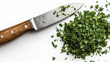 Captivating close-up image showcasing finely chopped fresh parsley next to a kitchen knife on a clean, bright white surface, ideal for culinary blogs, recipe websites, and food photography portfolios photo