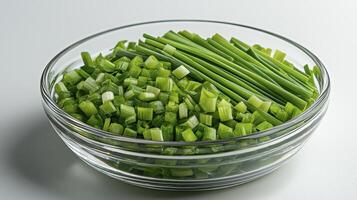 Captivating close-up showcases the vibrant freshness of chopped and whole green onions, nestled invitingly within a crystal-clear glass bowl, set against a pristine white backdrop, perfect for photo