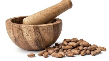 Discover the rustic charm of this beautifully captured still life, featuring a handcrafted wooden mortar and pestle set alongside a scattering of cocoa beans, evoking a sense of natural simplicity photo