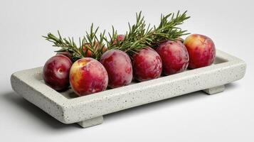 Elevate Your Culinary Vision with this Striking Still Life of Ripe Plums A symphony of deep reds, vibrant yellows, and lush greens, expertly arranged on a textured stone platter This evocative image photo