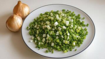 Fresh Chopped Green Onions and Whole Yellow Onions on a White Plate, Perfect for Cooking, Salads, or Garnishes Discover High-Quality Culinary Images Featuring Vibrant, Fresh Ingredients for Delicious photo