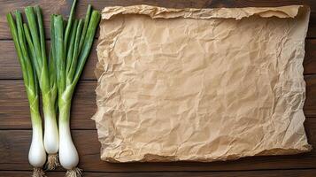 Fresh Green Onions and Vintage Paper on Rustic Wood, A Culinary Canvas Explore the vibrant hues of fresh scallions paired with the warm, aged texture of parchment paper resting upon weathered wooden photo