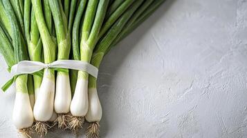 Fresh Green Onions on White Background A Culinary Delight Captured in High Resolution Discover the Vibrant Colors and Textures of These Spring Onions, Perfect for Enhancing Your Recipes and Visual photo
