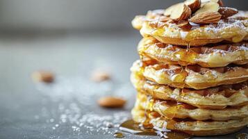 Indulge in a Delicious Stack of Golden Waffles A Tempting Treat Drizzled with Sweet Honey and Topped with Crunchy Almonds Perfect for Breakfast, Brunch, or a Decadent Dessert Enjoy the Warm photo