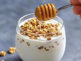 Delicious and Healthy Breakfast Idea Yogurt Parfait with Granola and Honey Drizzle for a Nutritious Start to Your Day Indulge in this Simple yet Satisfying Treat Featuring Creamy Yogurt, Crunchy photo