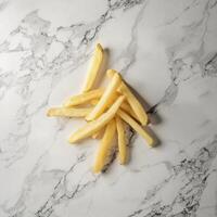 Delicious golden french fries arranged artfully on a pristine marble surface, a simple yet captivating still life that captures the essence of fast food favorites, perfect for culinary websites photo