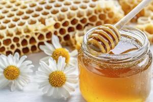 Discover the golden allure of nature's sweet elixir with this captivating image showcasing honey in all its glory, from the glistening jar to the intricate honeycomb, adorned with delicate white photo