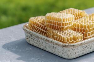 Discover the golden beauty of natural honeycomb, a raw and unprocessed delight from the hive Explore its intricate hexagonal cells, filled with pure, sweet honey, showcasing nature's perfect photo