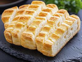 Golden, Fluffy Bread A Delicious Still Life Explore the inviting texture and warmth of freshly baked bread in this photograph, showcasing its appealing crust and soft interior Perfect for culinary photo