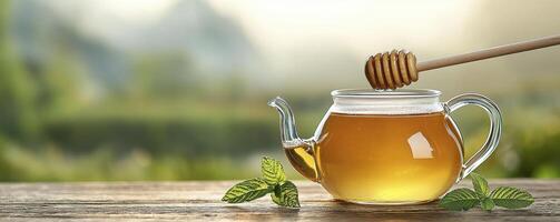 Golden Honey Tea Infusion A Refreshing and Healthy Beverage, perfect for Wellness and Relaxation, showcasing Natural Sweetness and Aromatic Flavors, served in a Delicate Glass Teapot with a Honey photo