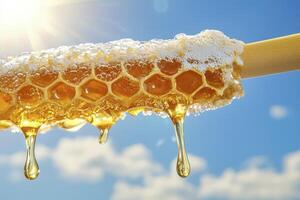 Golden honeycomb dripping with sweet honey against a bright blue sky, capturing the essence of nature's bounty and the deliciousness of pure, unfiltered goodness, evokes feelings of warmth photo