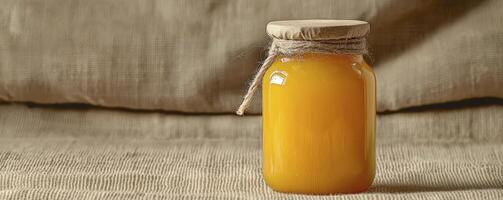 Golden Hour Honey Jar A captivating image showcasing a glass jar filled with luscious, golden honey, basking in the warm glow of natural sunlight, evoking feelings of sweetness and natural goodness photo