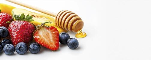 Healthy Eating with Fresh Fruits and Honey A Delicious Combination of Strawberries, Blueberries, Mango, and Natural Sweetness Perfect for breakfast, snacks, or desserts, this vibrant image showcases photo