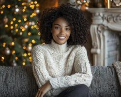 In a world of warmth, a woman sits, bathed in light's soft embrace, radiating happiness A cozy sweater clings to her form, a testament to comfort and style Christmas glows in the periphery, a festive photo