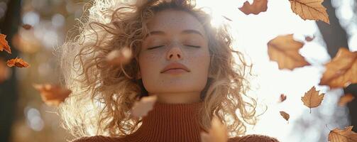 In the heart of autumn, a radiant woman stands, her curly hair bathed in a warm, golden backlit glow Falling leaves dance around her, creating a dreamlike, magical portrait Her eyes are closed, a photo