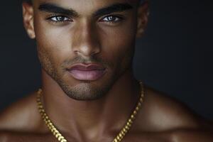 The captivating gaze of a man framed within a minimalist aesthetic, enhanced by a delicate gold chain that hints at understated luxury Neutral tones provide the backdrop for the portrait photo