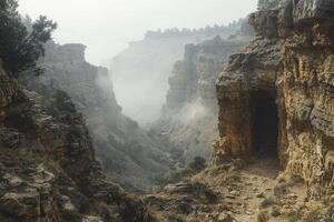 A hidden canyon, shrouded in mystery and ethereal fog, beckons with the promise of uncharted territories and untold adventures The rolling mist weaves through the rugged landscape, obscuring the path photo