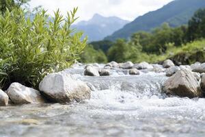 A serene landscape unfolds, where a gentle river gracefully cascades over smooth, sun-kissed pebbles, creating a soothing symphony of nature's music The crystal-clear water reflects the surrounding photo