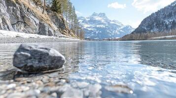 A serene mountain river flows with crystal clarity, its surface reflecting the sky Soft, white mist gently hovers just above the water, creating an ethereal, peaceful atmosphere The surrounding photo