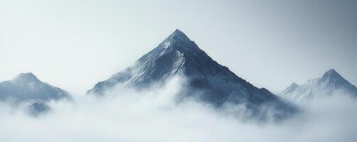 Above the world, a majestic mountain peak pierces through a swirling canvas of dense fog The scene evokes a sense of ethereal grandeur and serene isolation The jagged, snow-dusted summit rises as a photo
