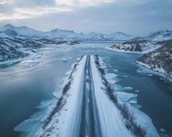 From a great height, we look down upon a scene of remarkable serenity and subtle peril The icy expanse stretches towards the horizon, its frozen embrace punctuated by the rugged silhouettes of photo