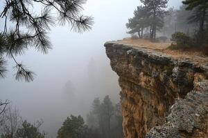 In a realm where the earth meets the sky, a majestic cliff face stands as a silent sentinel, its rugged edges softened by the caress of ethereal fog A dreamlike haze envelops the landscape, blurring photo
