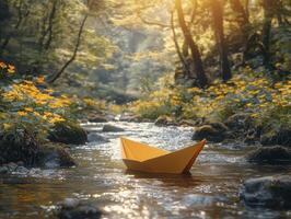 In a serene forest setting, a vibrant yellow paper boat embarks on a miniature voyage down a gentle stream Sunlight filters through the lush canopy, creating dappled patterns on the water's surface photo