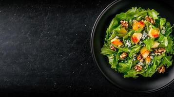 Fresh and colorful salad arranged on a black plate with vibrant vegetables and greens ready for a healthy meal photo